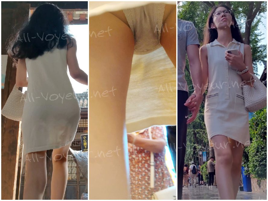 白いドレスを着て眼鏡をかけ、灰色の下着を身につけた若い女性が散歩に出かけていた。